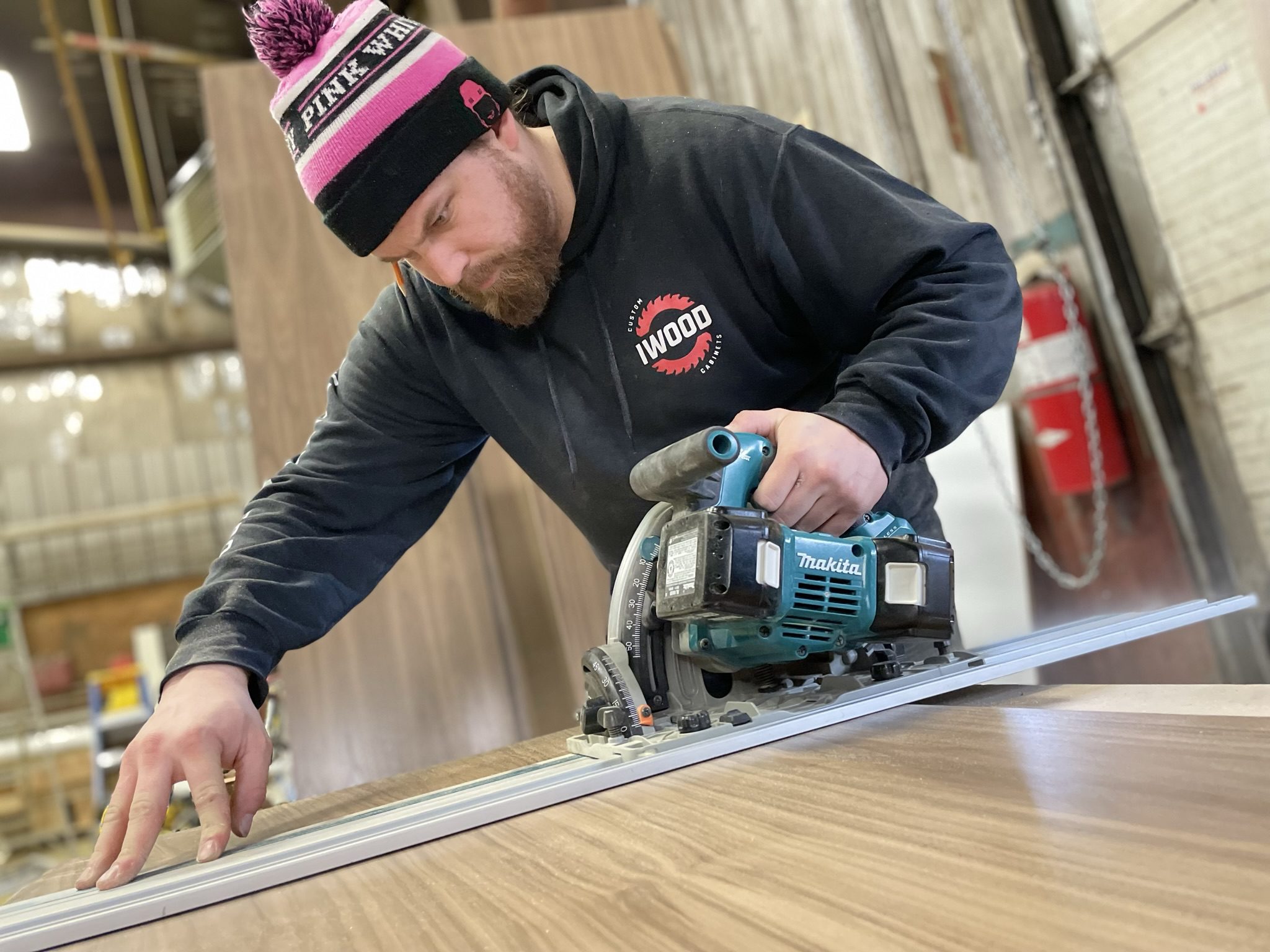 Max Michieli cutting plywood with a track saw in the IWood shop
