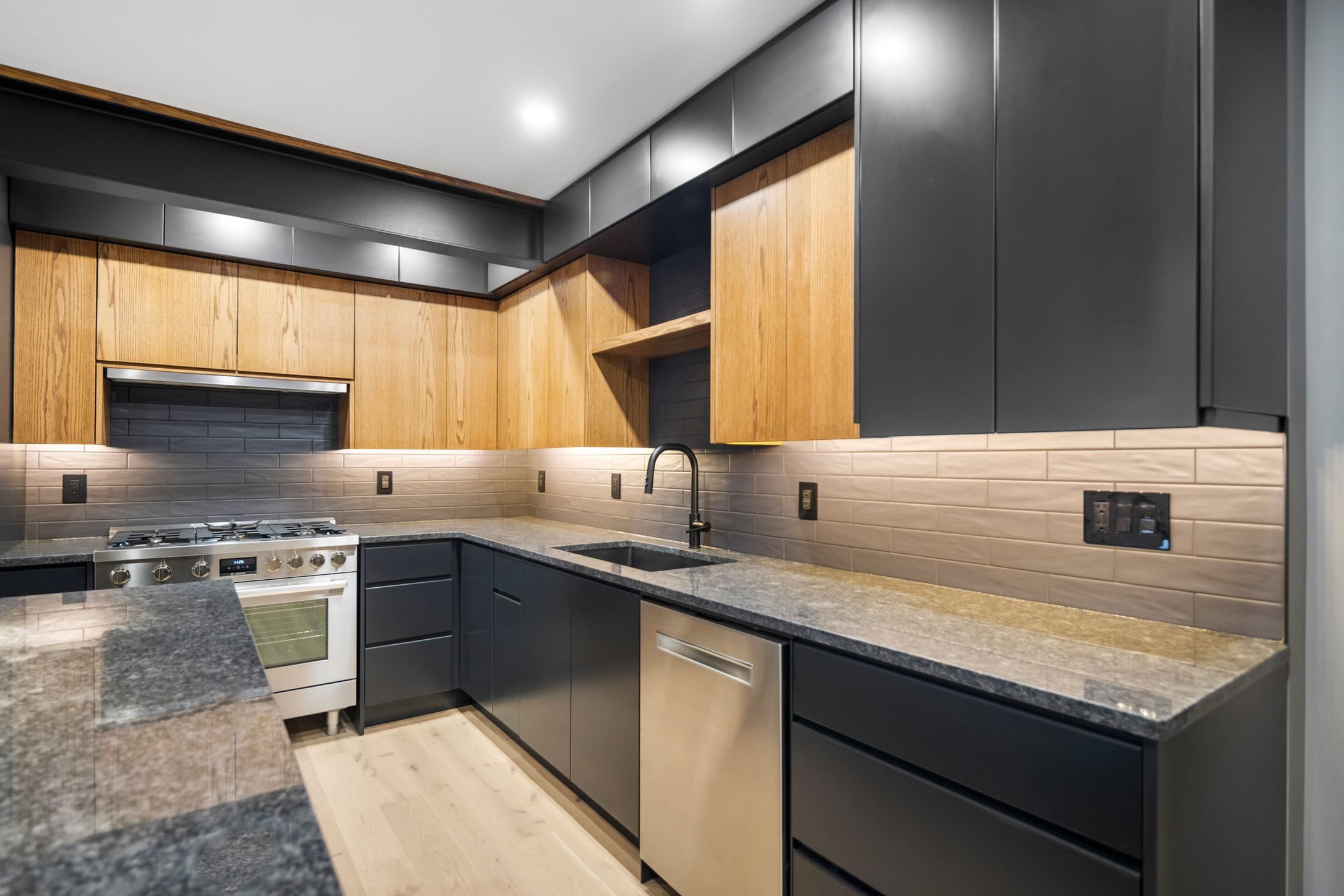 Modern dark kitchen with oak accents
