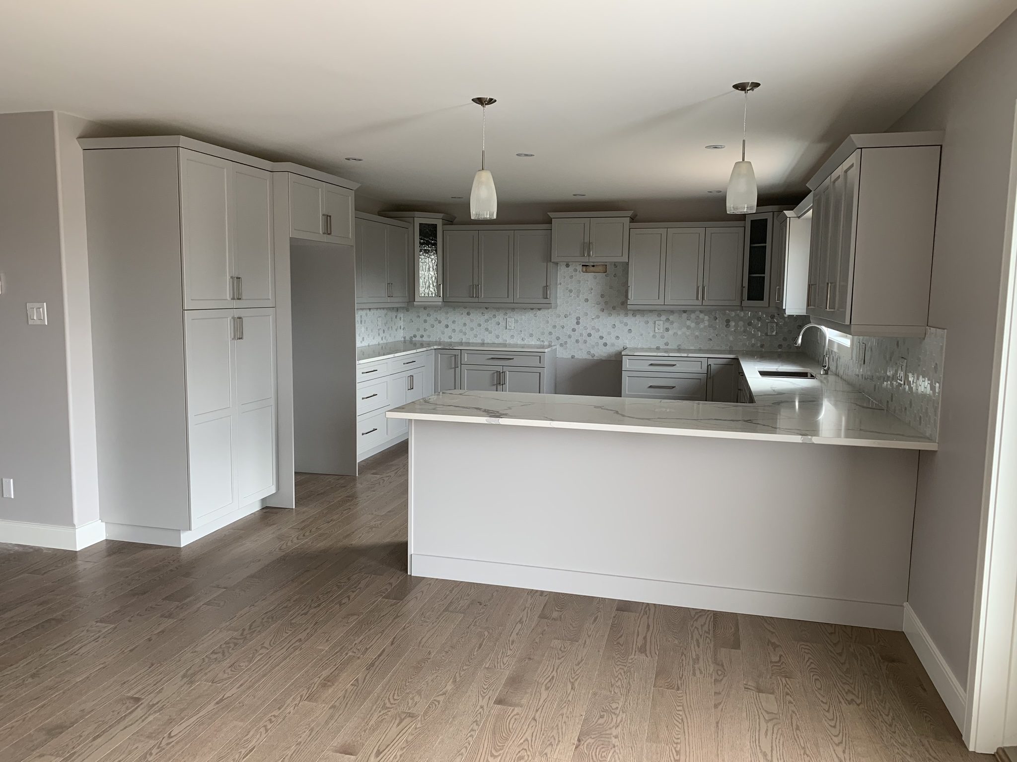 Grey shaker kitchen with marble countertops