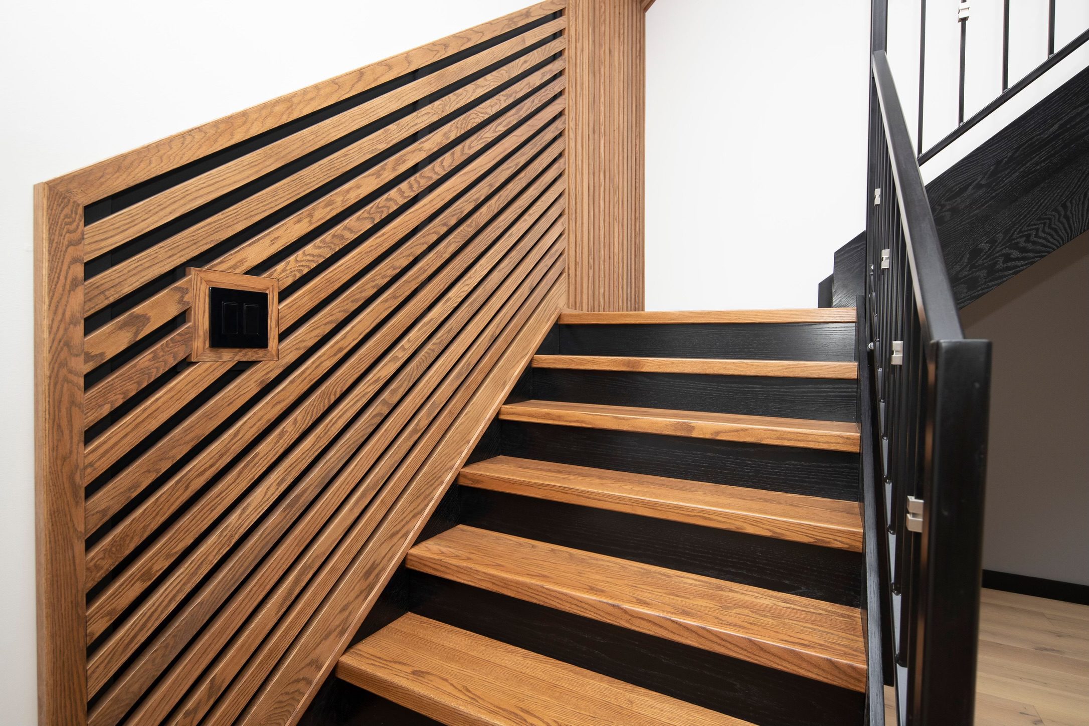 Custom oak staircase with slat wall